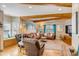 Cozy living room with wood beams, hardwood floors, and comfortable leather seating at 28 Rebellion Rd, Charleston, SC 29407