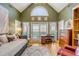 A living room with a vaulted ceiling, a large arched window, and sliding doors to a balcony at 28 Rebellion Rd, Charleston, SC 29407