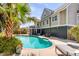 Backyard pool area with lounging chairs, lush greenery, and a glimpse of the home's exterior at 28 Rebellion Rd, Charleston, SC 29407