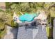 Aerial view of a backyard pool and jacuzzi surrounded by a patio and seating area at 28 Rebellion Rd, Charleston, SC 29407