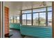 Bright sunroom featuring blue beadboard, multiple windows, and water views at 28 Rebellion Rd, Charleston, SC 29407