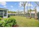 Lush backyard with green grass, a modern fence, and a charming stone fire pit for outdoor enjoyment at 2830 Backman St, Mount Pleasant, SC 29466