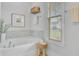 Bright bathroom showcasing a soaking tub, window, and elegant decor at 2830 Backman St, Mount Pleasant, SC 29466