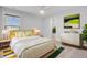 Bright bedroom featuring a queen bed, ceiling fan, neutral decor, and an ensuite bathroom entrance at 2830 Backman St, Mount Pleasant, SC 29466