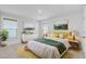 Cozy bedroom with two windows, landscape art, a queen bed, and a yellow and gray rug at 2830 Backman St, Mount Pleasant, SC 29466