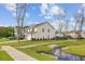 Beautiful home showcasing a well-kept lawn, a flowing creek, and scenic neighborhood views at 2830 Backman St, Mount Pleasant, SC 29466
