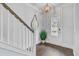 Welcoming foyer with wood floors, staircase, decorative mirror, and stylish lighting fixture at 2830 Backman St, Mount Pleasant, SC 29466