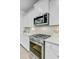 Modern kitchen with stainless steel appliances, white cabinets, and herringbone backsplash at 2830 Backman St, Mount Pleasant, SC 29466