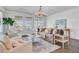 Sunlit living room with a decorative chandelier, comfortable seating, and large windows at 2830 Backman St, Mount Pleasant, SC 29466