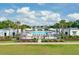 Community pool with lounge chairs, umbrellas, landscaping, and access to cabanas for relaxing in the sun at 2830 Backman St, Mount Pleasant, SC 29466