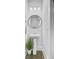 Elegant powder room featuring a pedestal sink, round mirror, and modern lighting at 2830 Backman St, Mount Pleasant, SC 29466