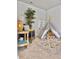 Cozy bedroom featuring a stylish teepee, a comfortable chair, and a charming woven side table with decorative accents at 2901 Backman St, Mount Pleasant, SC 29466