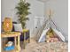 Cozy bedroom featuring a stylish teepee, a comfortable chair, and a charming woven side table with decorative accents at 2901 Backman St, Mount Pleasant, SC 29466