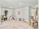 Large, bright bonus room with a seating area, teepee, study nook, decorative ladder and ample room to spread out at 2901 Backman St, Mount Pleasant, SC 29466