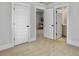 Hallway with open doorways and neutral walls connects living spaces, offering a glimpse of the study nook and bathroom at 2901 Backman St, Mount Pleasant, SC 29466
