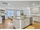 Open-concept kitchen featuring a large center island, stainless steel appliances, and hardwood floors, flowing into the living area at 2901 Backman St, Mount Pleasant, SC 29466