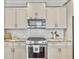 Well-equipped kitchen boasts stainless steel appliances, tiled backsplash, and beautiful stone countertops at 2901 Backman St, Mount Pleasant, SC 29466