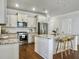 Spacious kitchen with a center island, marble countertops, stainless steel appliances, and wooden bar stools at 2901 Backman St, Mount Pleasant, SC 29466