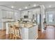 Well-lit kitchen with a center island, white cabinets, stainless steel appliances, and hardwood floors at 2901 Backman St, Mount Pleasant, SC 29466
