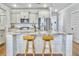Modern kitchen boasts a large center island with seating, stainless steel appliances, and sleek white cabinetry at 2901 Backman St, Mount Pleasant, SC 29466