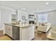 Open concept living room and kitchen featuring a fireplace, comfortable seating, and a large kitchen island at 2901 Backman St, Mount Pleasant, SC 29466