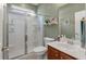 A well-lit bathroom boasts a glass enclosed shower, wood vanity, and large mirror at 2940 Amberhill Way, Charleston, SC 29414