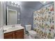 Bathroom with patterned shower curtain and single sink vanity with storage underneath at 2940 Amberhill Way, Charleston, SC 29414