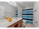 Neutral bathroom features a wood vanity and shower/tub with striped shower curtain at 2940 Amberhill Way, Charleston, SC 29414