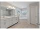 Bright bathroom features a double sink vanity and a garden tub with natural light at 2940 Amberhill Way, Charleston, SC 29414
