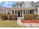 Inviting home exterior with a covered porch and meticulously landscaped front yard at 2940 Amberhill Way, Charleston, SC 29414