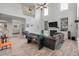 Open living room with a cozy fireplace, large windows, and hardwood floors at 2940 Amberhill Way, Charleston, SC 29414