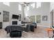 Bright living room featuring high ceilings, large windows, fireplace, and hardwood floors at 2940 Amberhill Way, Charleston, SC 29414