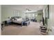 Spacious main bedroom featuring an elegant bed frame, neutral carpet, and ample natural light at 2940 Amberhill Way, Charleston, SC 29414