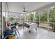 Enclosed sunroom with ceiling fan, tile floor, and large windows, providing a relaxing space with views of the backyard at 2940 Amberhill Way, Charleston, SC 29414