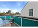 Balcony with wooden floors, turquoise rails, outdoor furniture, and neighborhood views at 3 1/2 Maranda Holmes St # B, Charleston, SC 29403