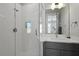 Bathroom featuring a glass-enclosed shower, white subway tile, gray cabinets, and white countertops at 3 1/2 Maranda Holmes St # B, Charleston, SC 29403