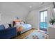 Bright bedroom features a door to the exterior and an area rug on the wood floor at 3 1/2 Maranda Holmes St # B, Charleston, SC 29403
