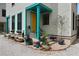 A home's front porch featuring decorative turquoise trim, potted plants, and pea gravel ground cover at 3 1/2 Maranda Holmes St # B, Charleston, SC 29403