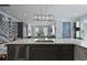 Open-concept kitchen with stainless steel appliances, quartz countertop, stylish lighting, and seamless flow into the living area at 3 1/2 Maranda Holmes St # B, Charleston, SC 29403