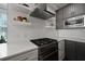 Modern kitchen features stainless steel appliances, quartz counters, subway tile backsplash and custom floating shelving at 3 1/2 Maranda Holmes St # B, Charleston, SC 29403
