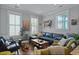 Comfortable living room with large windows, plush seating, and wood floors at 3 1/2 Maranda Holmes St # B, Charleston, SC 29403