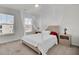 A bedroom with a neutral color scheme features a soft bed canopy and ample natural light from the windows at 307 Blue Oak Dr, Moncks Corner, SC 29461