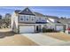 Two-story home featuring a two-car garage and a well-manicured lawn and landscaping at 307 Blue Oak Dr, Moncks Corner, SC 29461