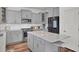 Bright kitchen features gray cabinets, stainless steel appliances, and a center island with a quartz countertop at 307 Blue Oak Dr, Moncks Corner, SC 29461