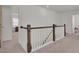 A spacious landing with white walls and dark wood trim, with bedrooms off to the sides at 307 Blue Oak Dr, Moncks Corner, SC 29461