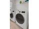 A bright laundry room features front-load machines and a convenient shelf for supplies at 307 Blue Oak Dr, Moncks Corner, SC 29461