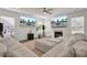 Bright living room with large windows, fireplace, and plush sectional sofa for cozy living at 307 Blue Oak Dr, Moncks Corner, SC 29461