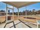 Outdoor patio with a screened enclosure and views of the backyard with a grill and trampoline at 307 Blue Oak Dr, Moncks Corner, SC 29461