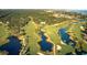 Picturesque aerial view of a golf course featuring lush fairways, tranquil water hazards, and manicured greens at 3110 Up Da Creek Ct, Seabrook Island, SC 29455