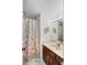 Bright bathroom featuring a seashell patterned shower curtain and vanity with a mirror at 3110 Up Da Creek Ct, Seabrook Island, SC 29455